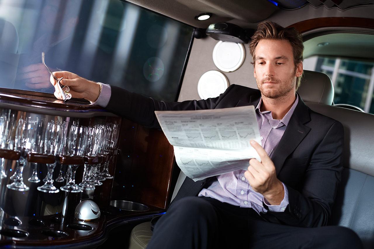 reading news in limo
